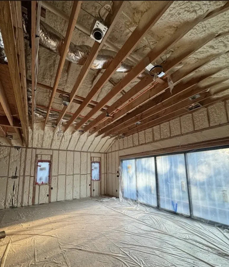 Interior walls and ceiling insulated with spray foam during new construction in Chelsea